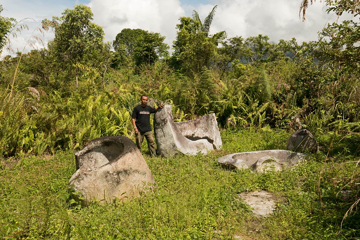 Broken kalambas with archaeologist Iksam Djorimi, near Kolori village, Bada Valley