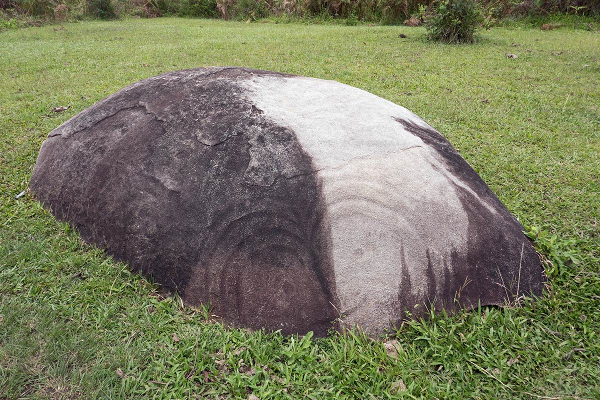 Watu Molindo monolith with enigmatic face etched on surface, near Bulili village, Besoa Valley